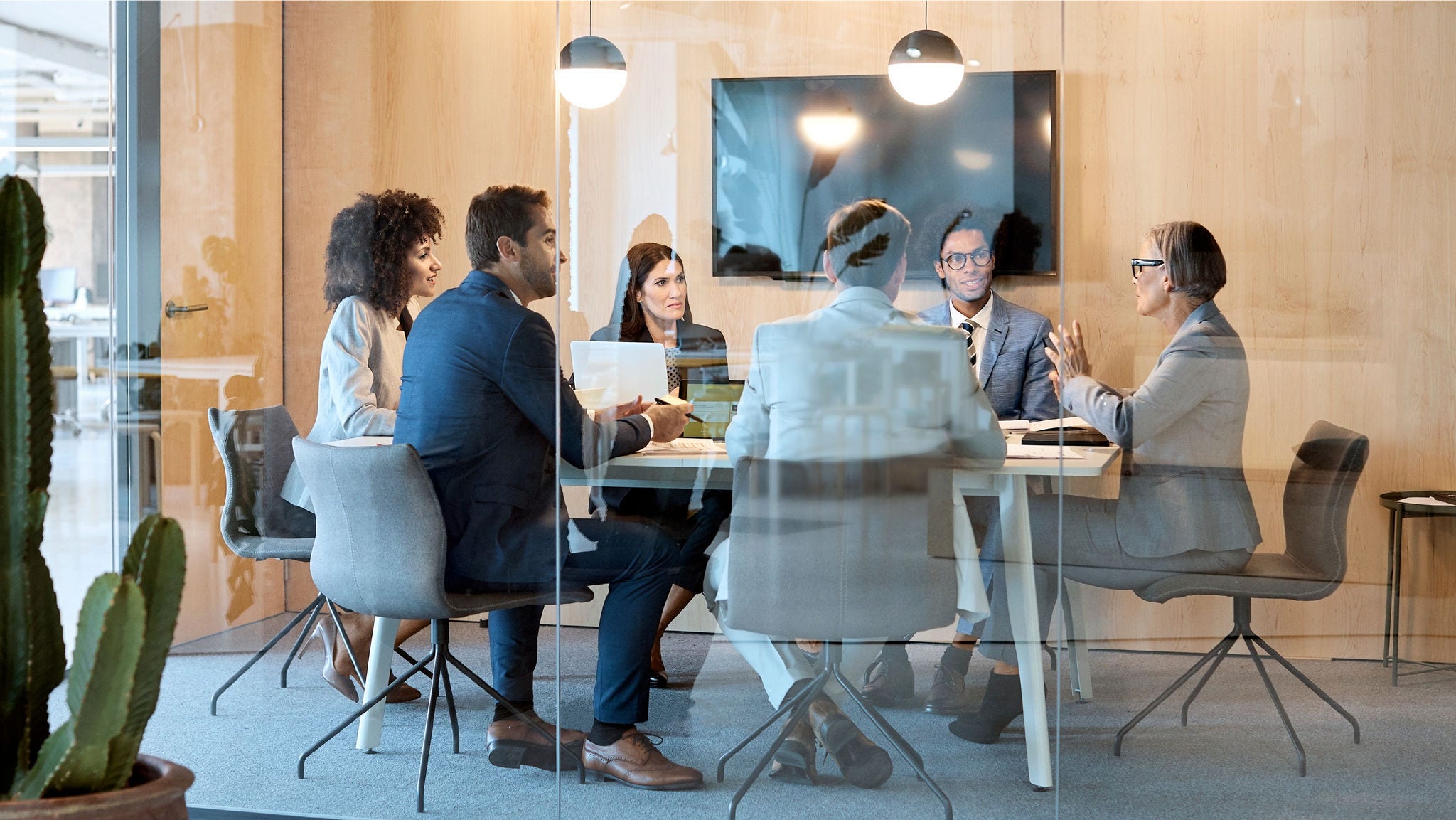 Executives meet in a board room. 