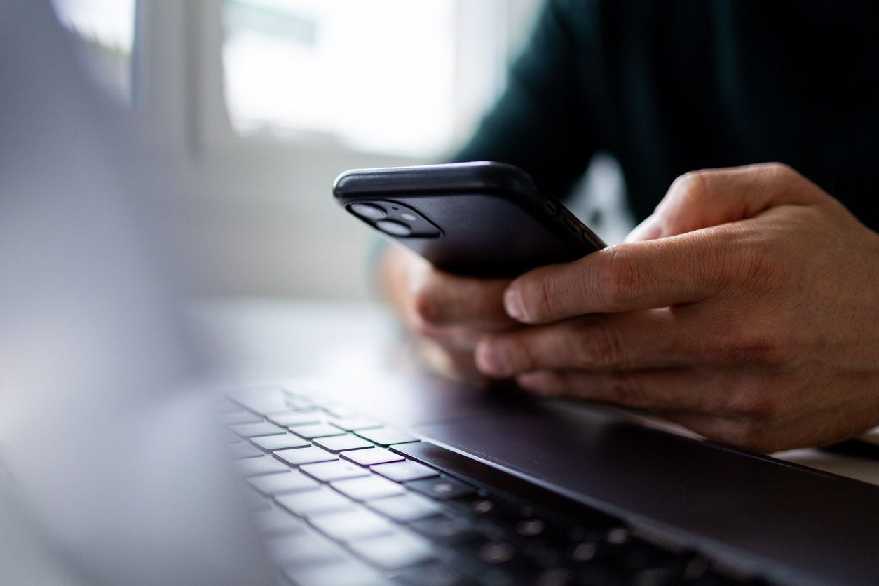 1934523700 business person looking at smartphone