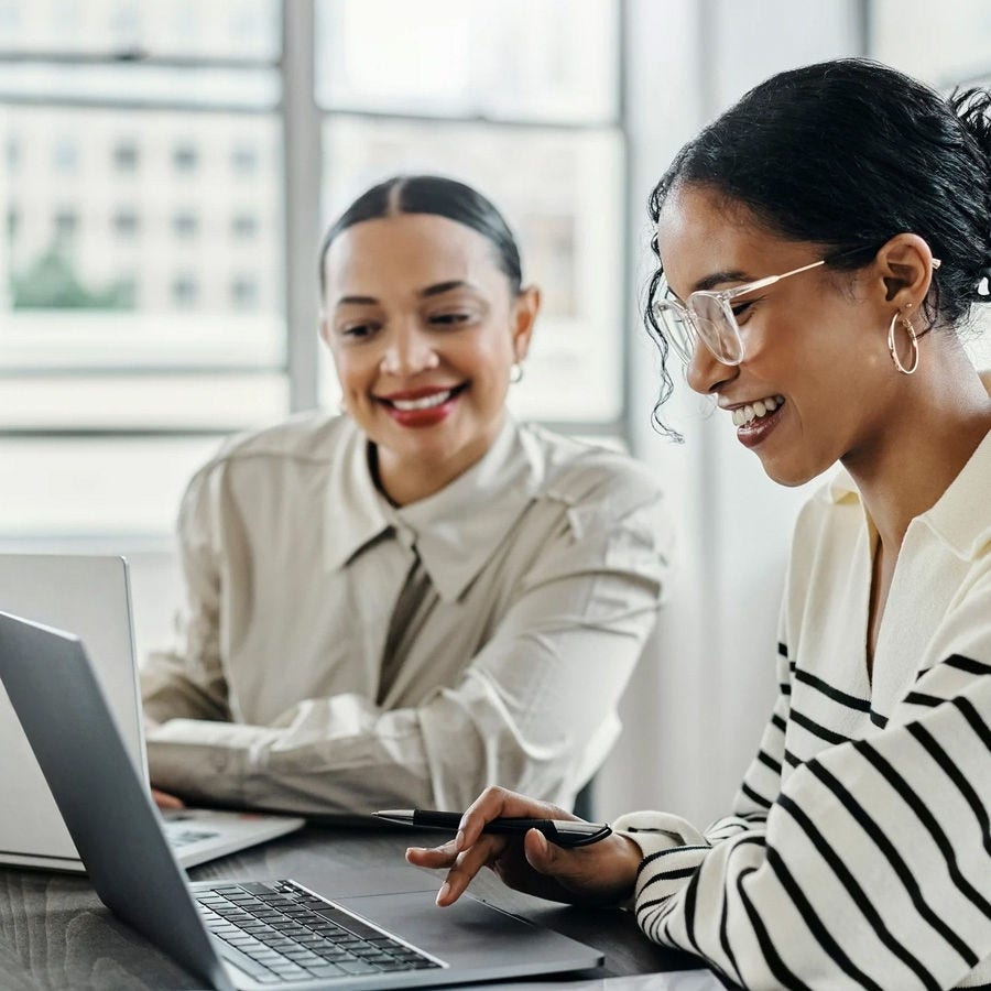 Happy workers looking at a laptop screen