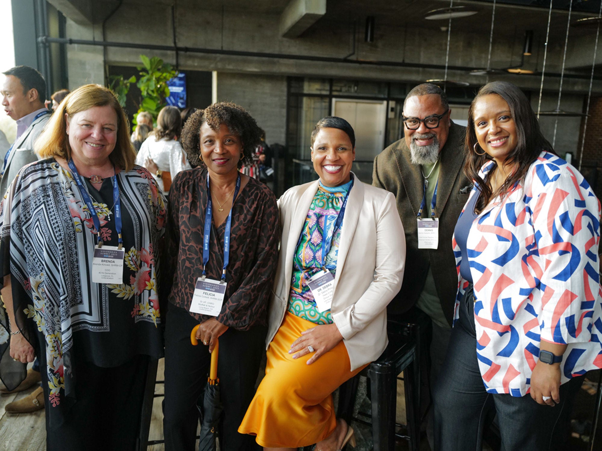 Conference attendees smile at the camera.