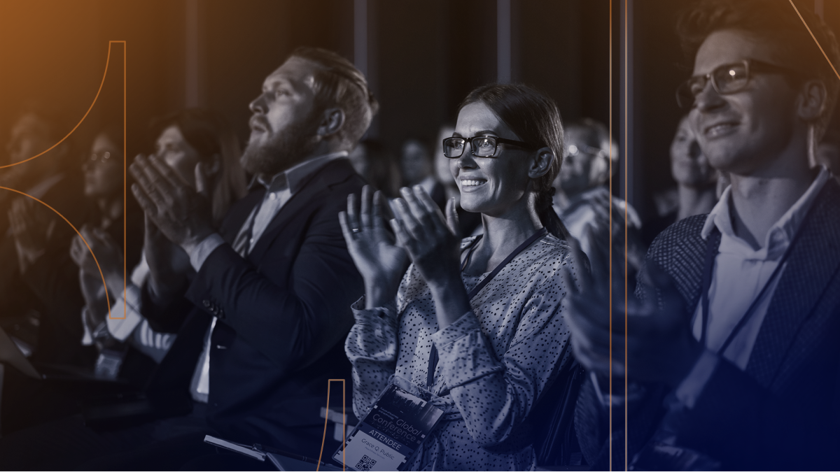 Executives clapping at a conference.