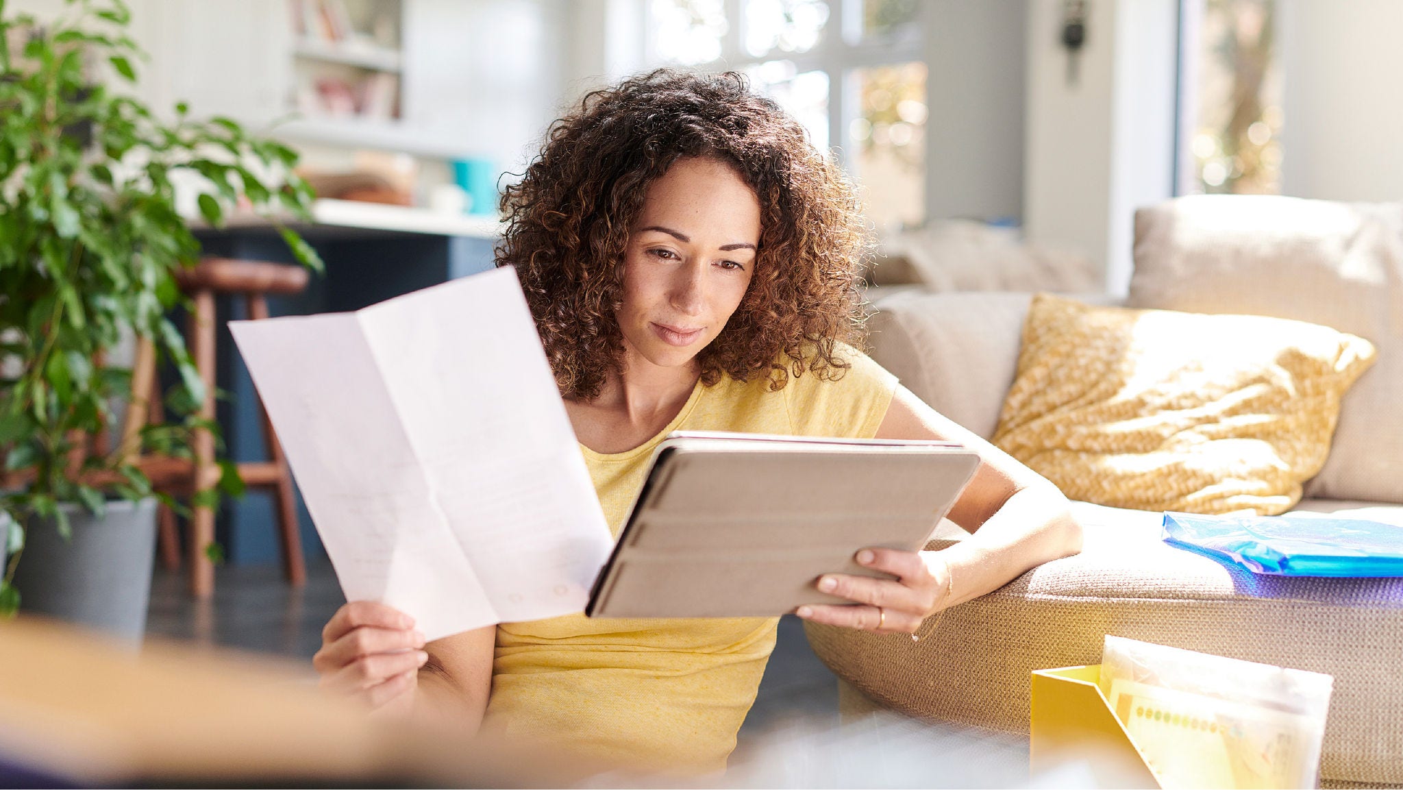 woman exams paperwork at home