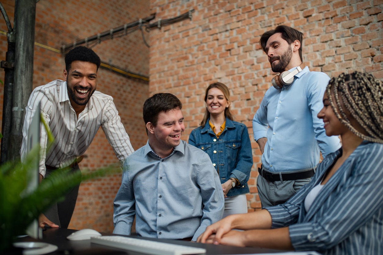diverse coworkers laughing and smiling together
