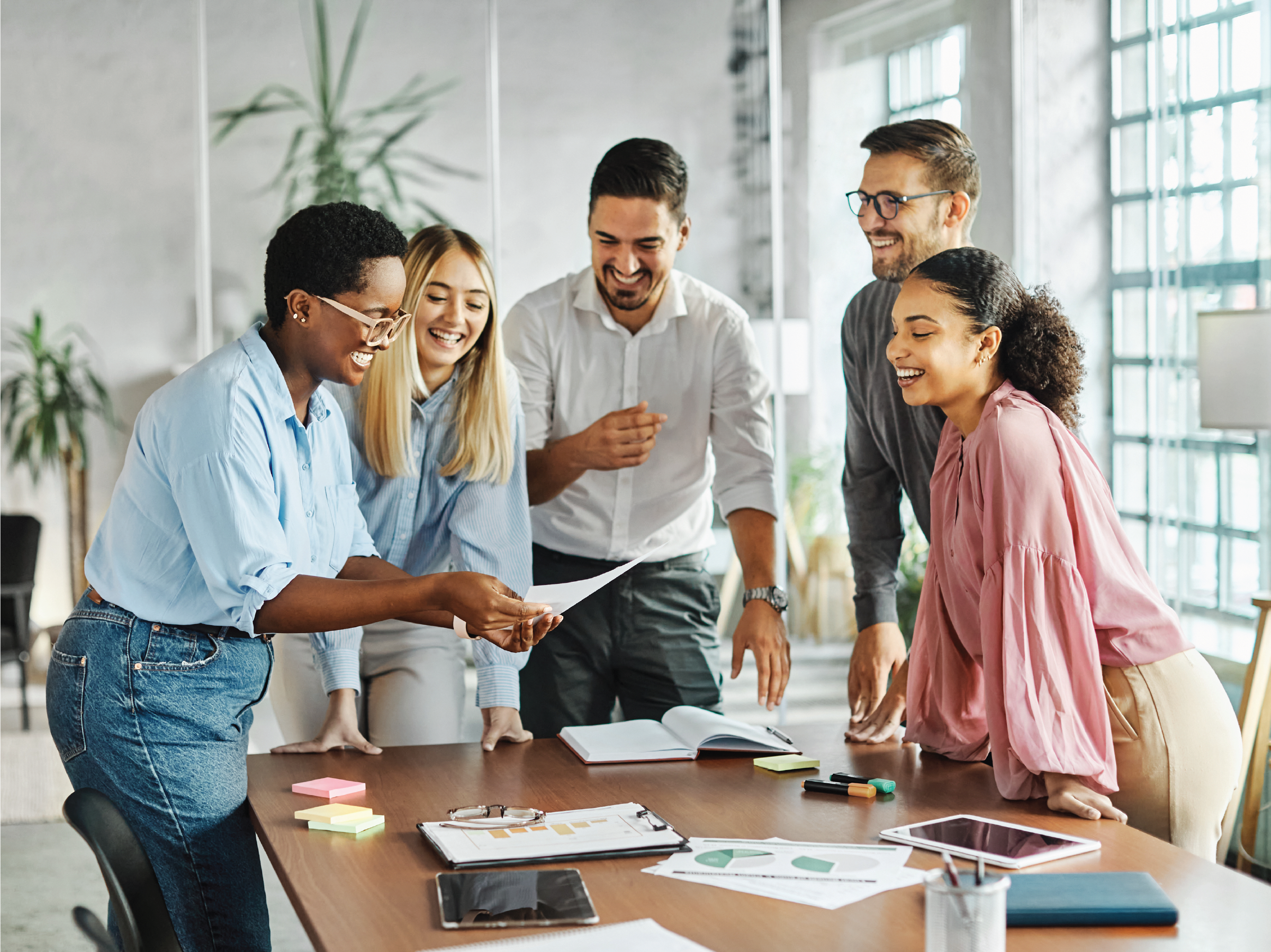 group of coworkers collaborating around a table in an office