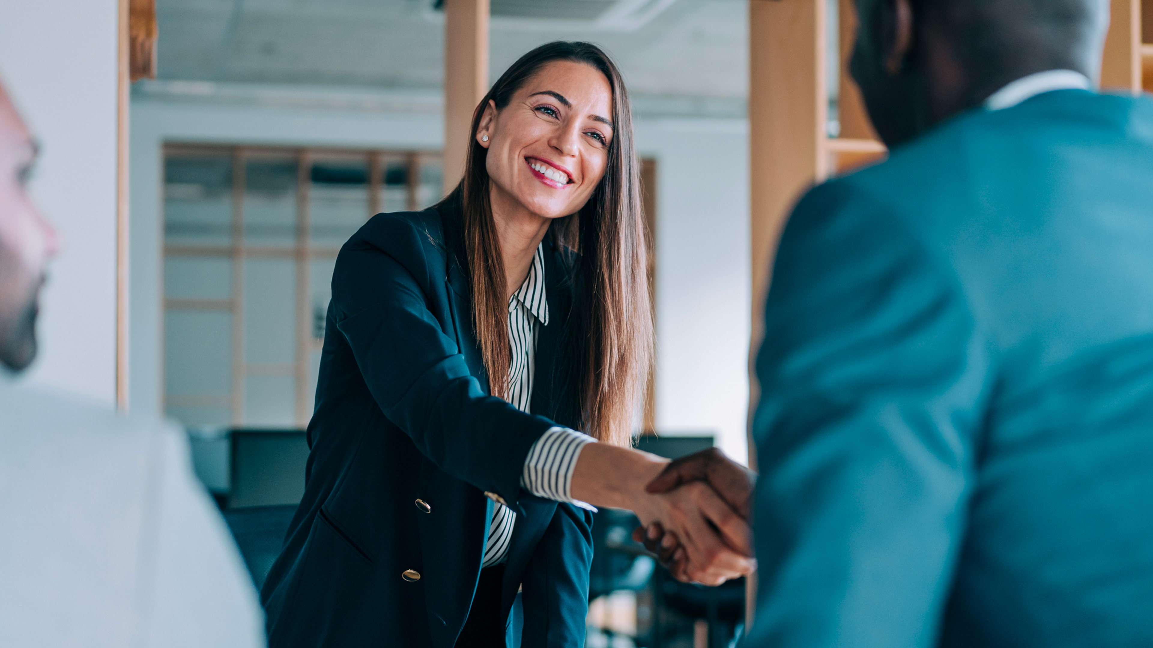 businesswoman shakes hands with businessman