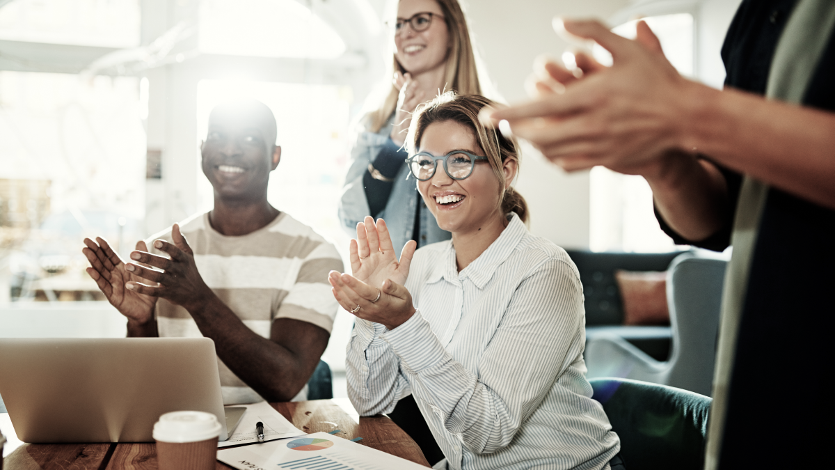 Employees celebrate my clapping during a meeting