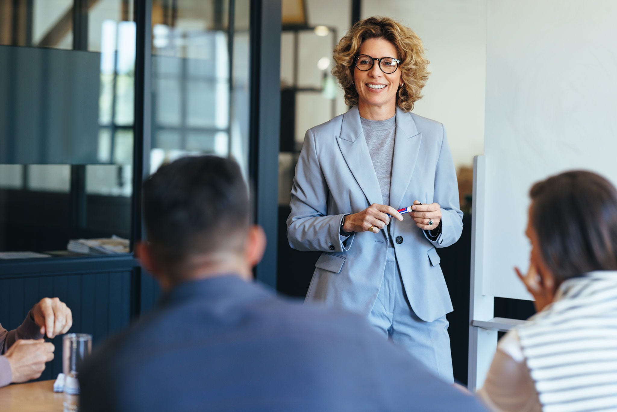 businesswoman presents to colleagues in an office