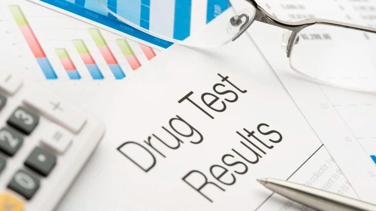 What laws should companies be aware of when implementing a drug testing program?