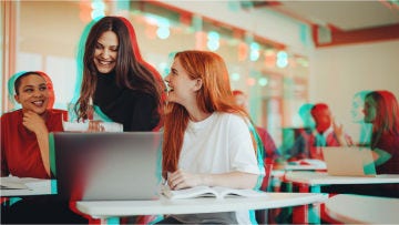 girl looking with friends at computer