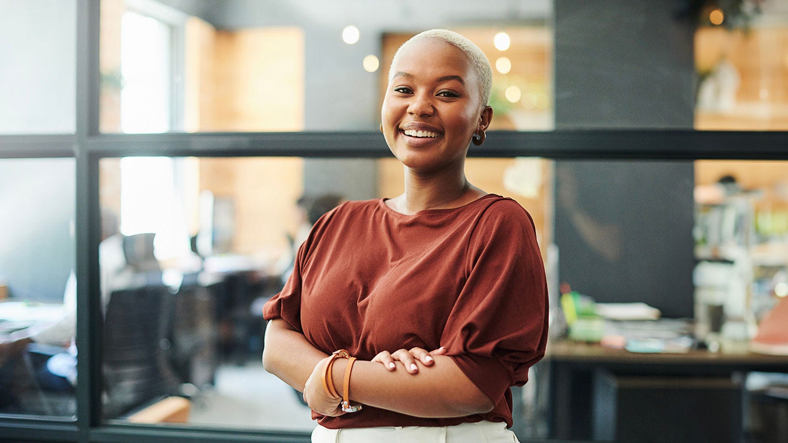 Middle-aged African American female human resources professional smiling and standing confidently in an office setting