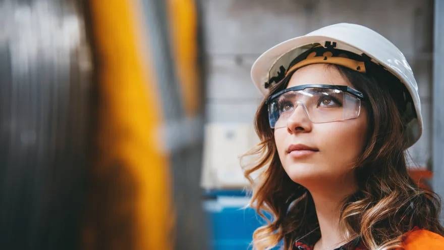 Woman wearing a hard hat and safety goggles