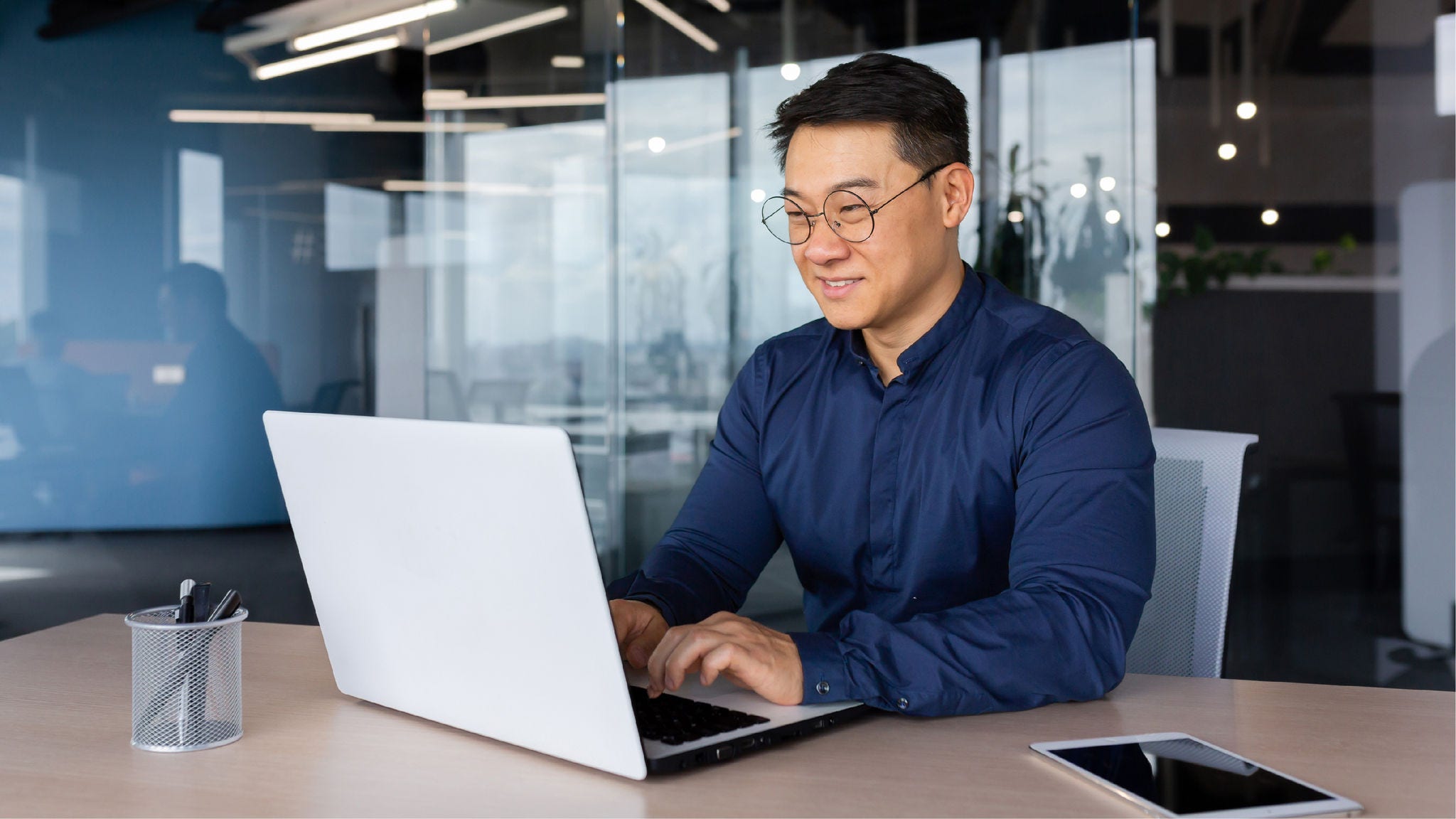 Employee works on laptop.