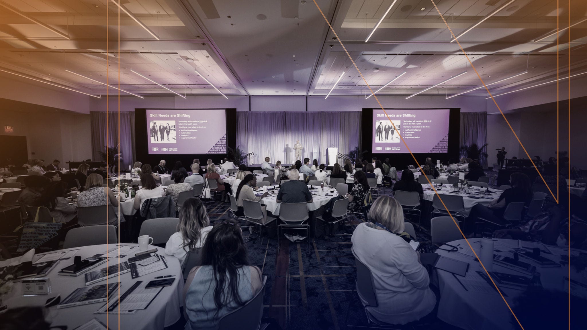 Conference attendees listen to a presentation.