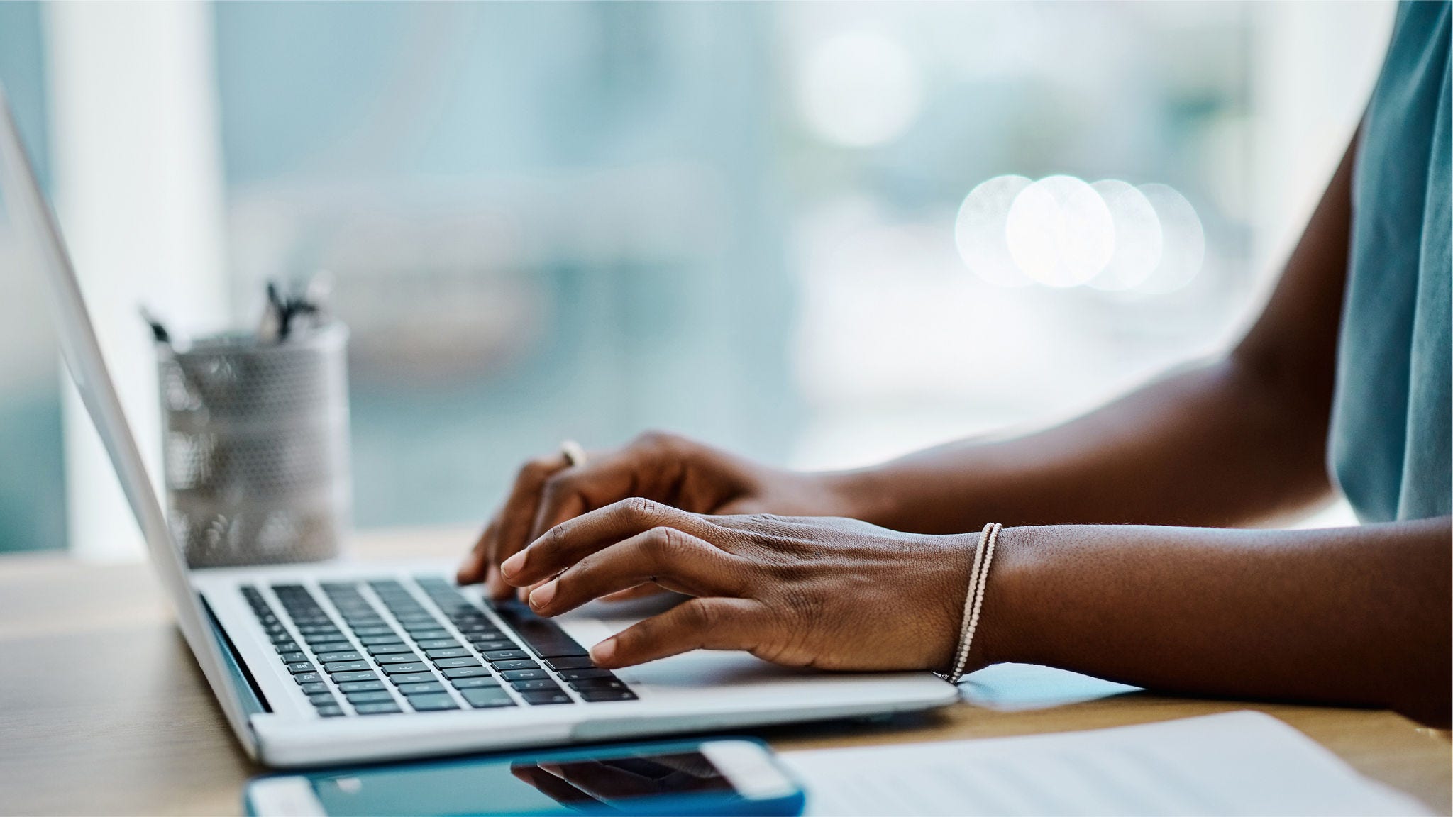 Woman types on laptop.