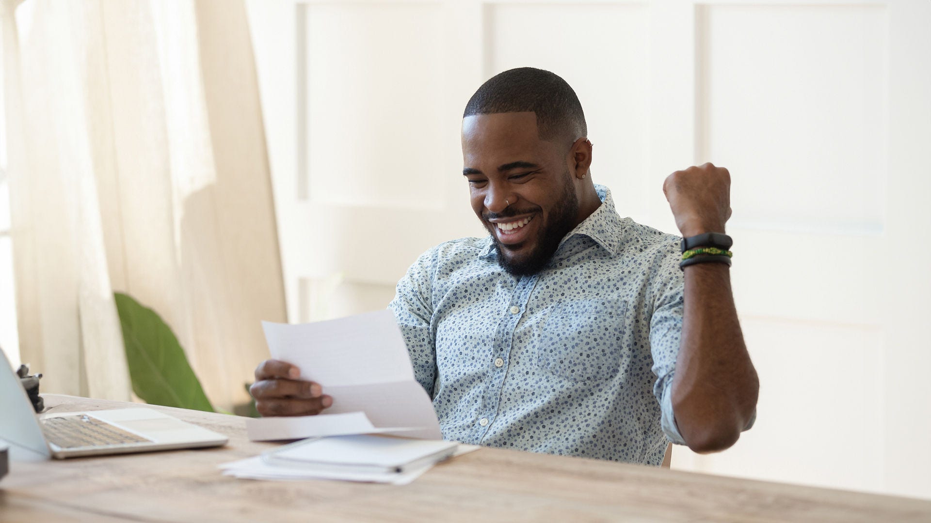 man holding paper excited