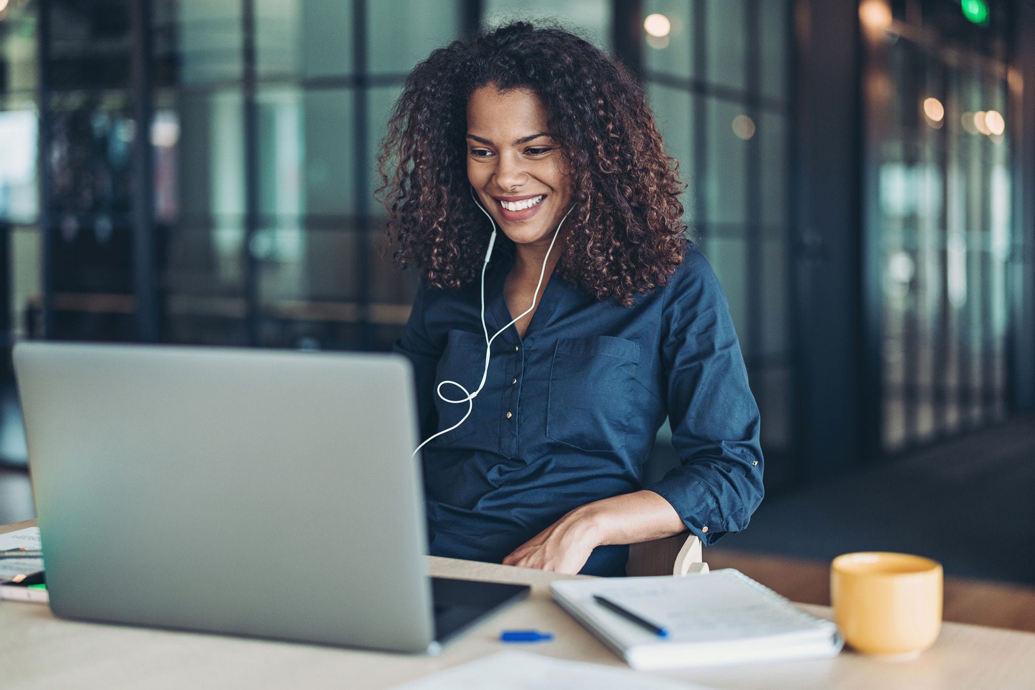 Businesswoman with laptop and headphones in the office