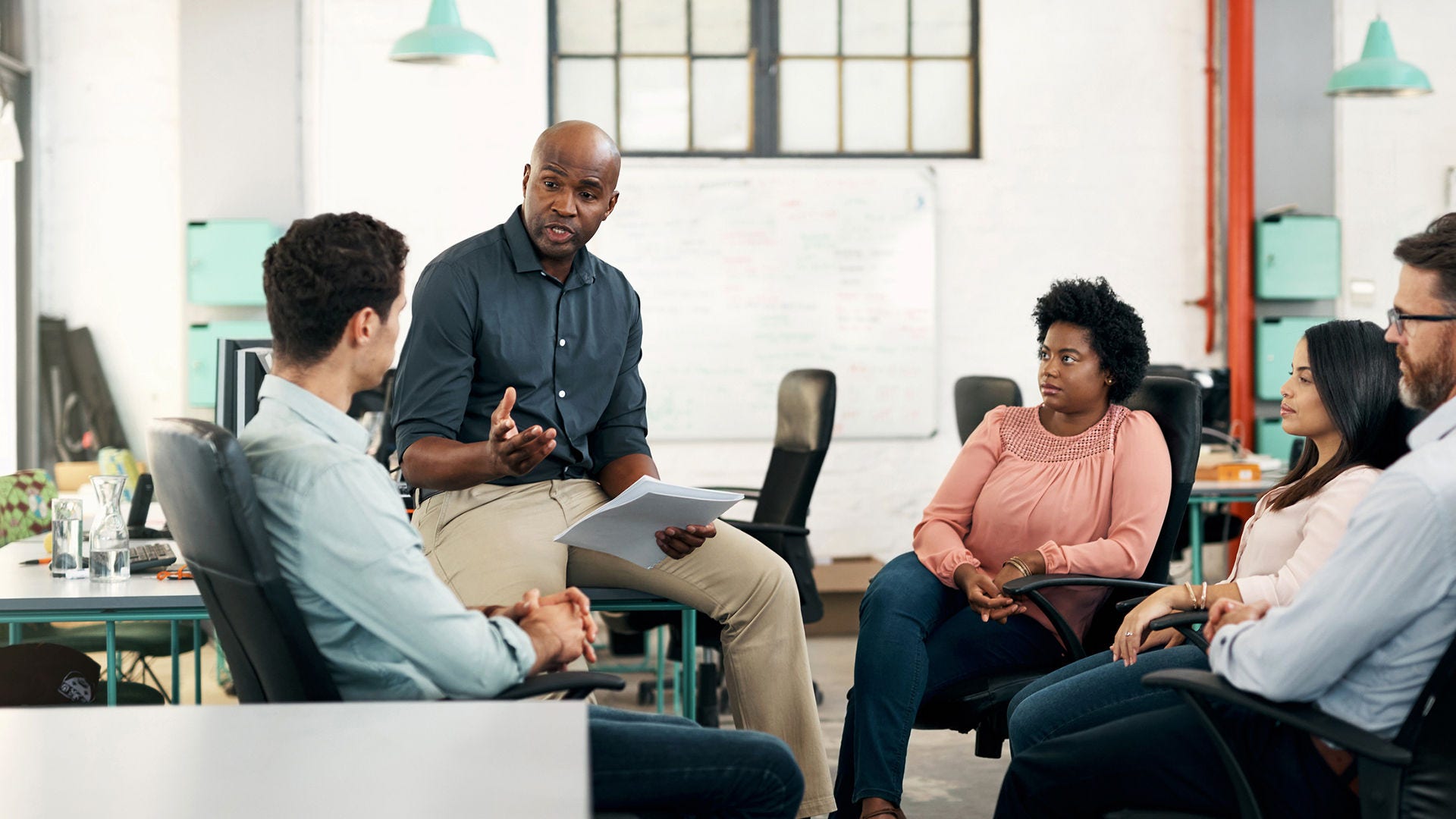 coworkers seated in an office setting discussing