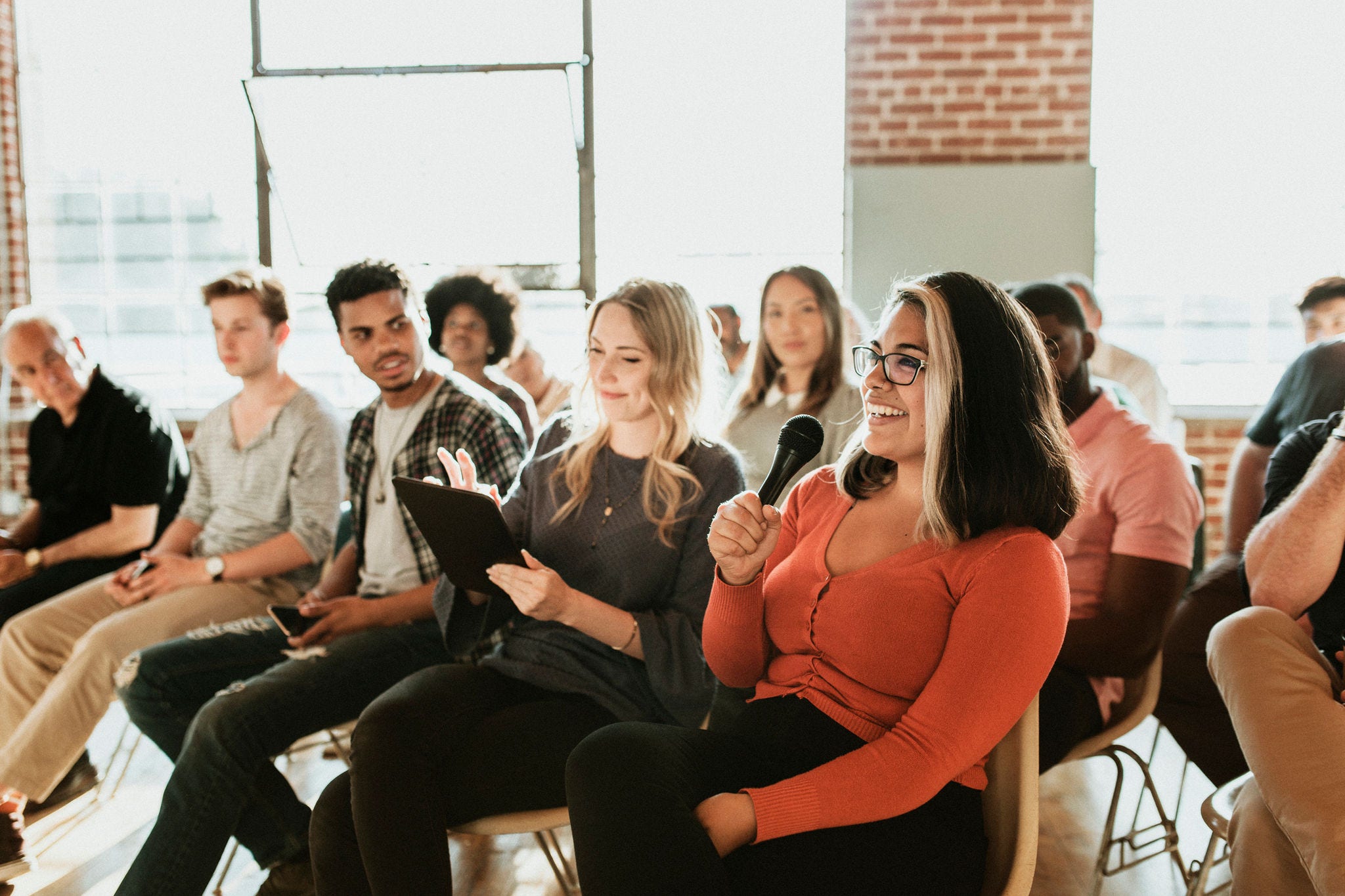 2157540714 Cheerful woman speaking on a microphone in a workshop