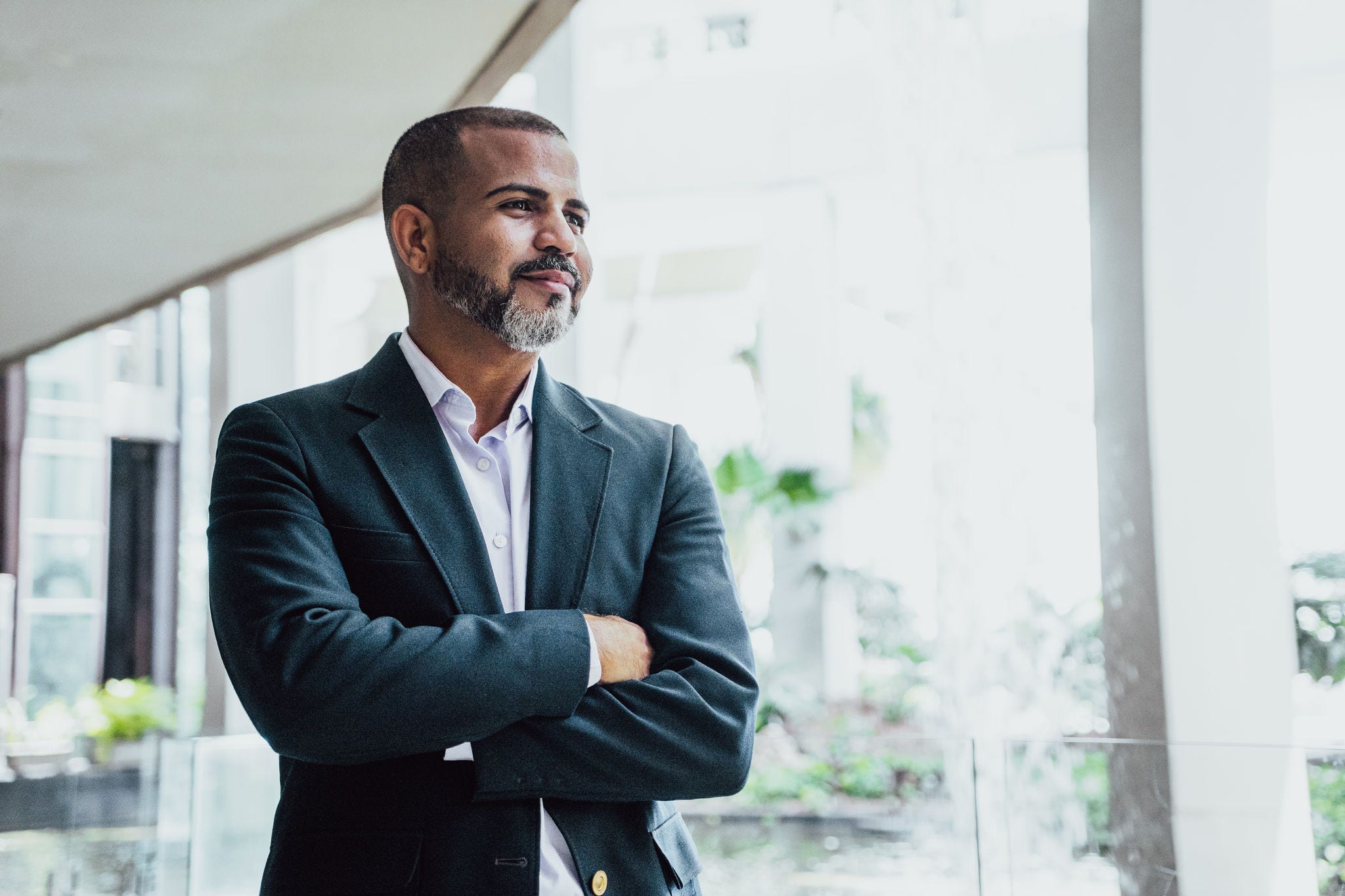 Mid adult businessman looking away and contemplating at balcony