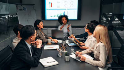 coworkers meeting at a table in a conference room