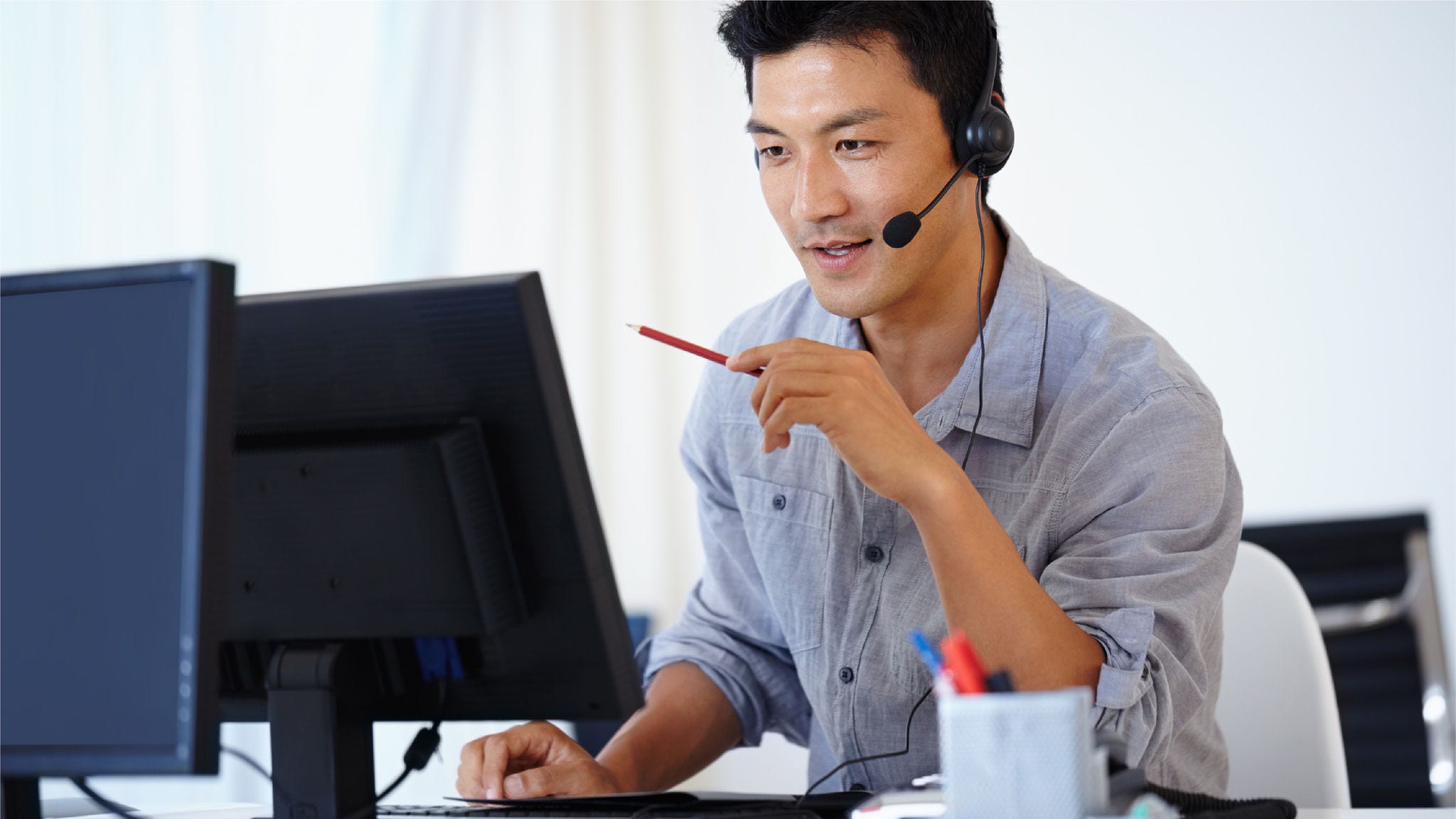 Man talks into his headset for a virtual meeting.