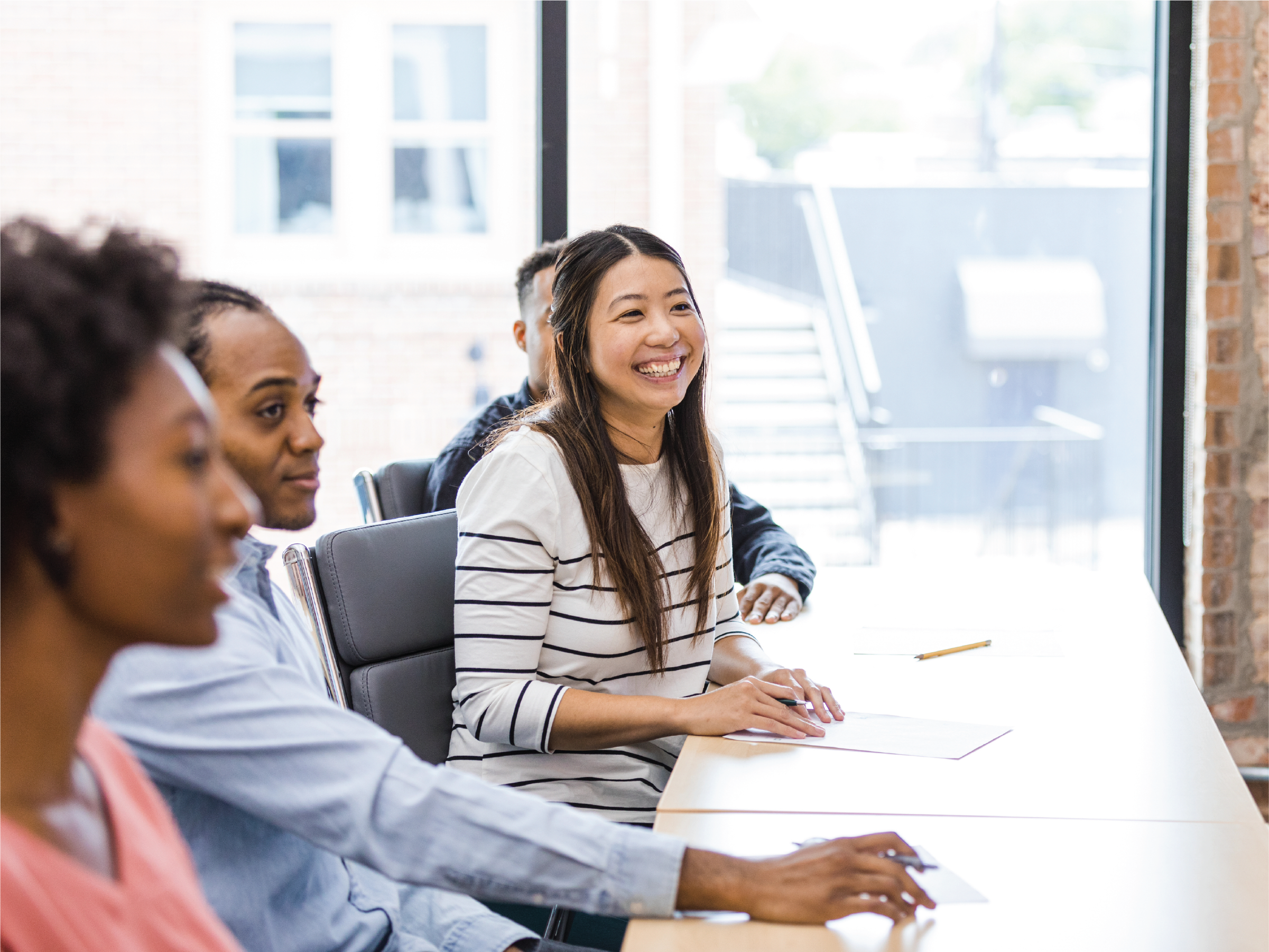 Employee laughs during an informational session.