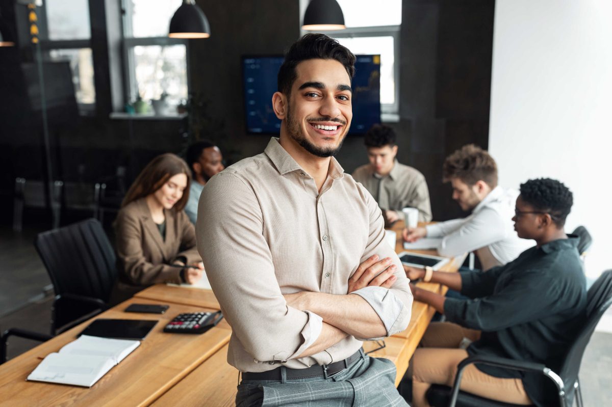 man smiling with team