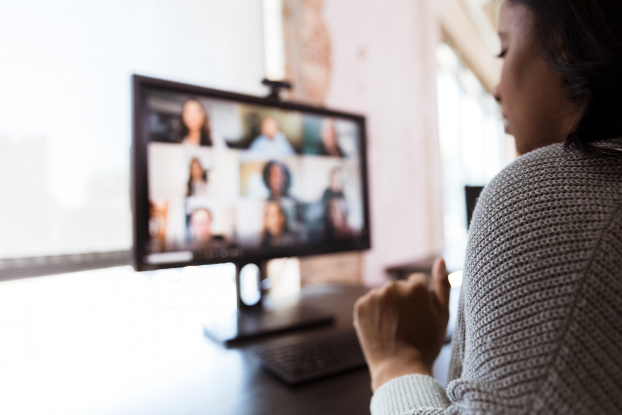 Woman video conferences with co-workers during pandemic