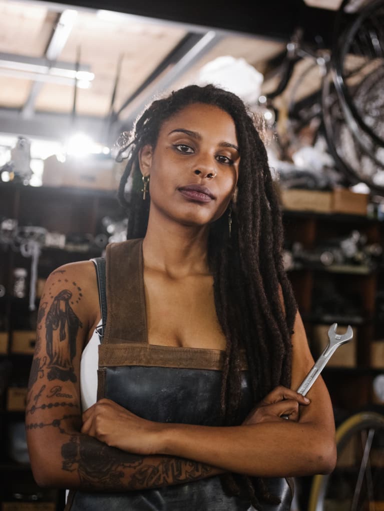 Photo of woman with tattoos on her arms.