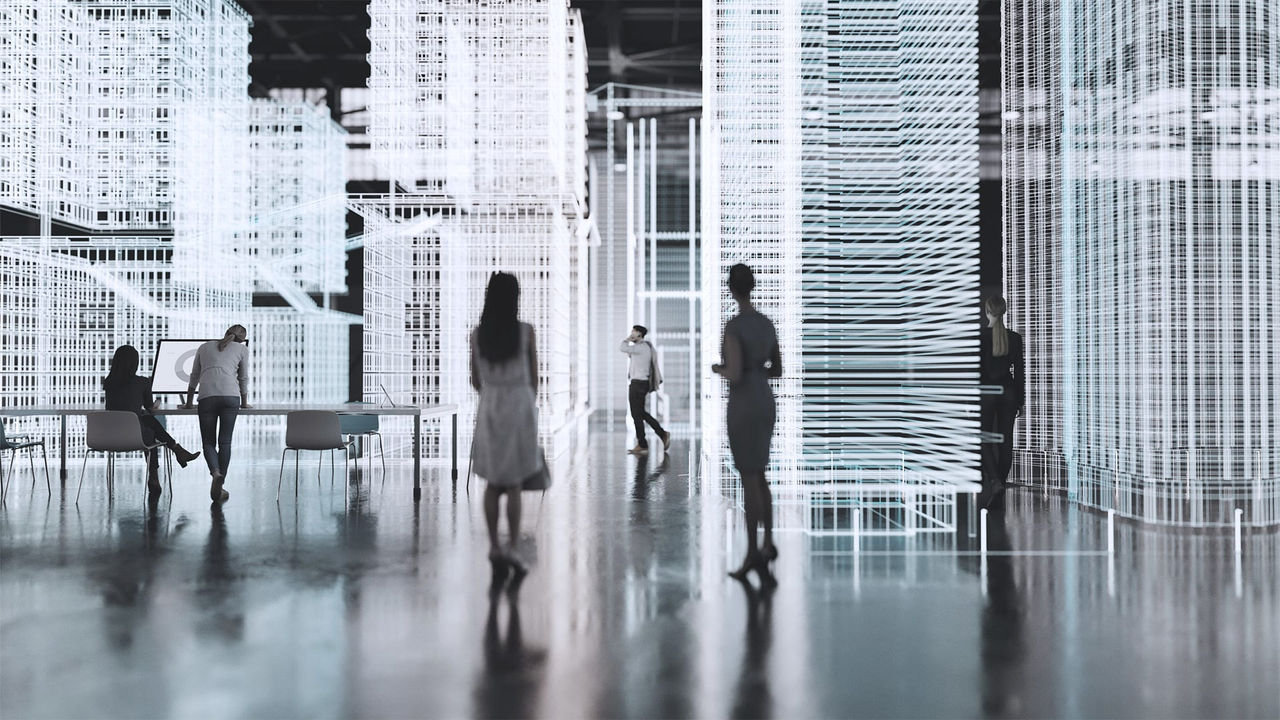 A group of people walking in an office building.