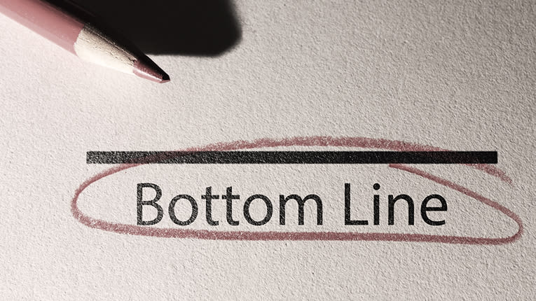 A pencil with the word bottom line written on it.