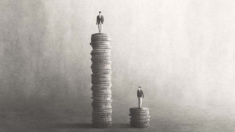Two people standing on top of stacks of coins.