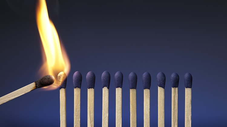 A group of matches burning on a blue background.