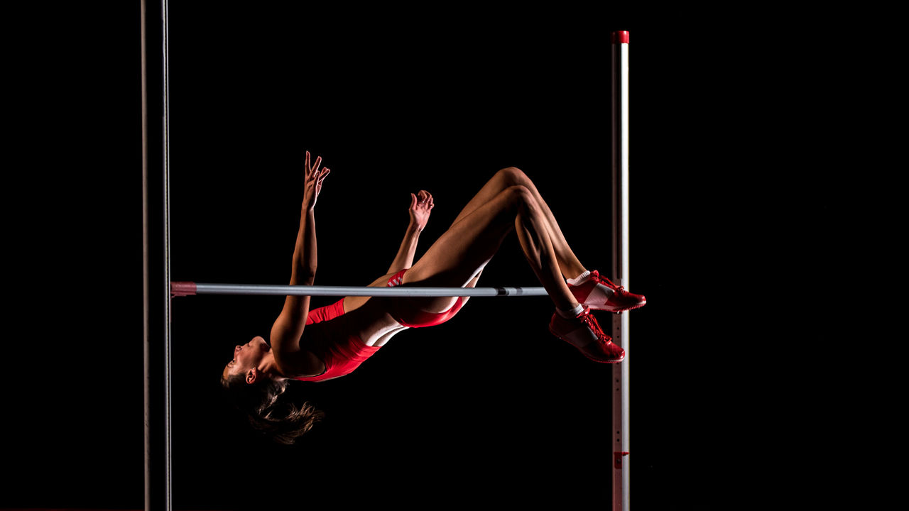 A woman is doing a high jump on a pole.