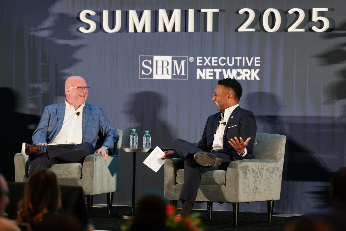 Jackson O. Lynch, seated on the left, and Johnny C. Taylor, seated on the right, in conversation on stage at the Visionaries Summit.