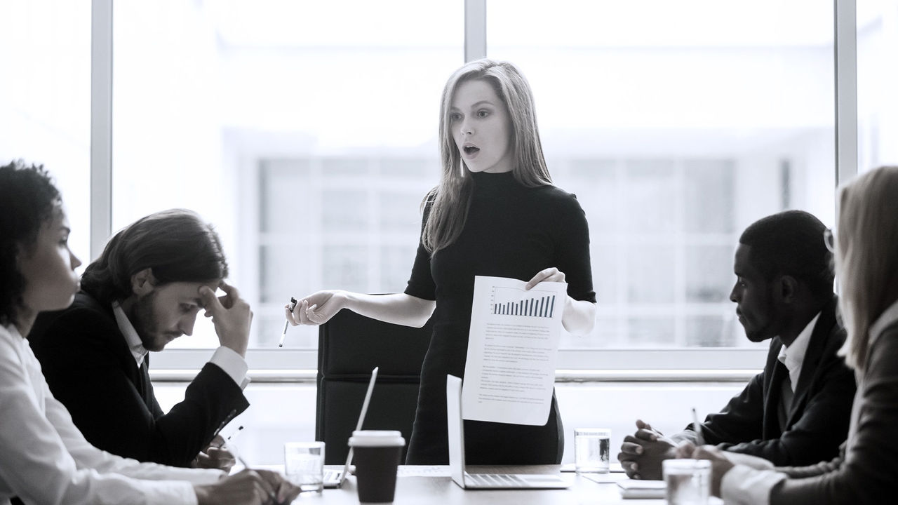 A woman is giving a presentation to a group of people.