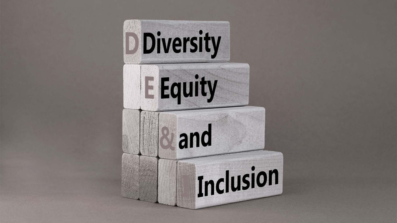 A stack of wooden blocks with the words diversity, equity and inclusion.