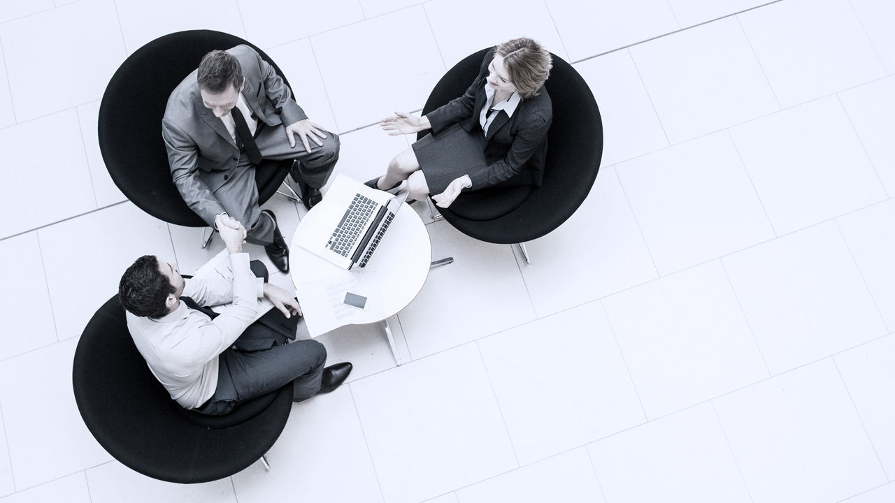 three business people talking