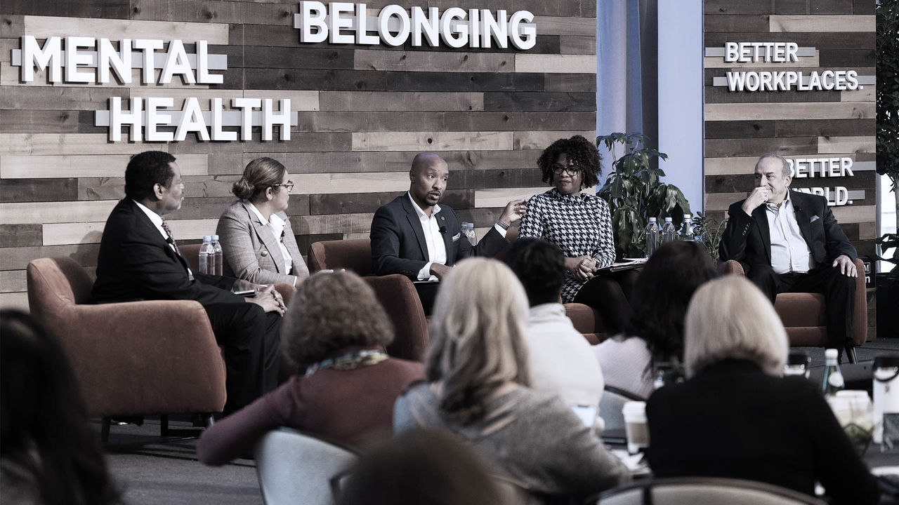 A group of people sitting on chairs at a mental health event.