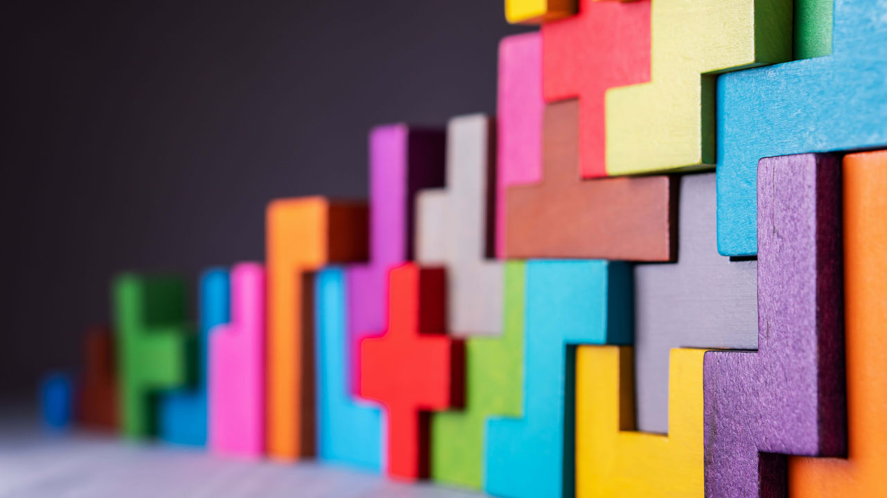 A row of colorful wooden blocks on a dark background.