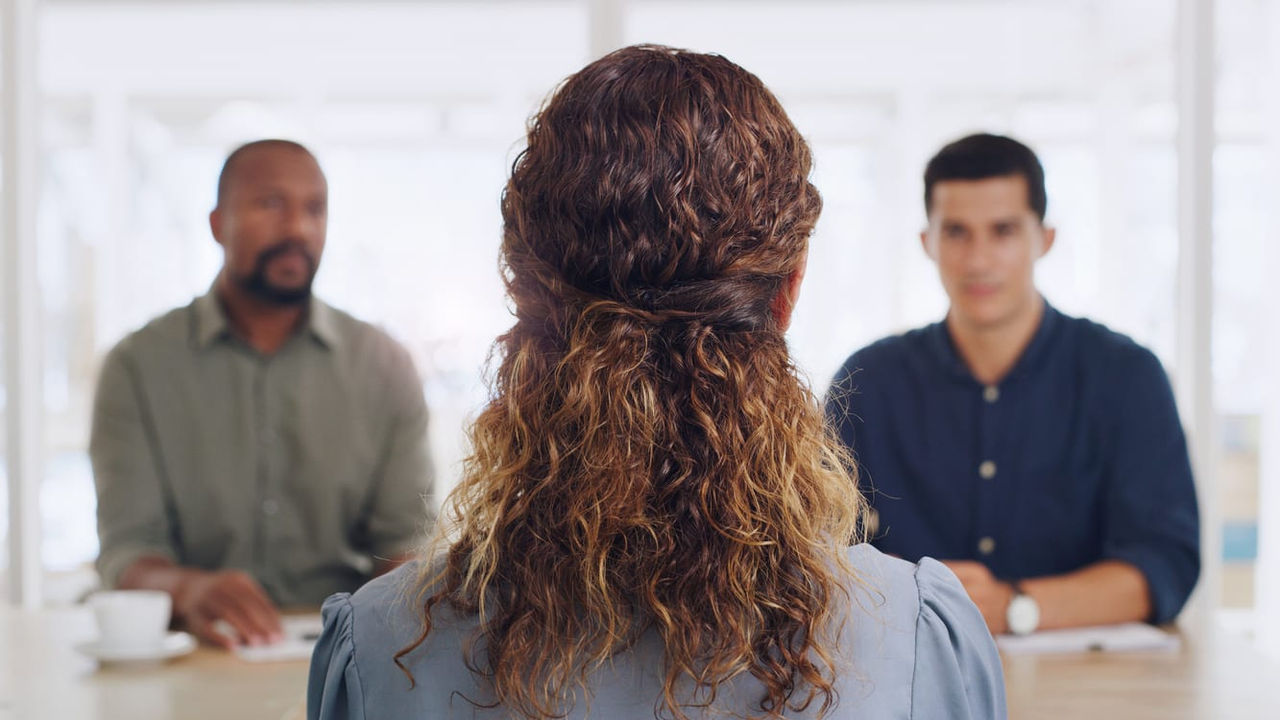 A group of people sitting at a table in a conference room.