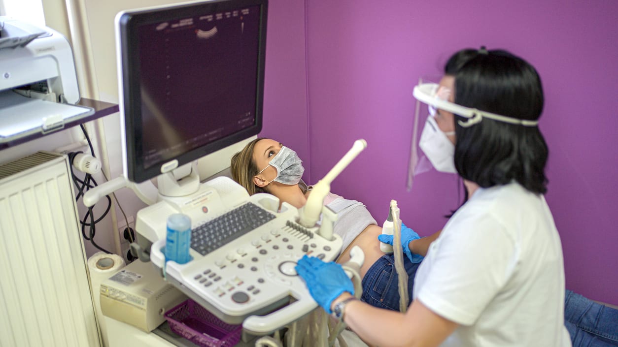 A woman is being examined by a doctor in a dental office.