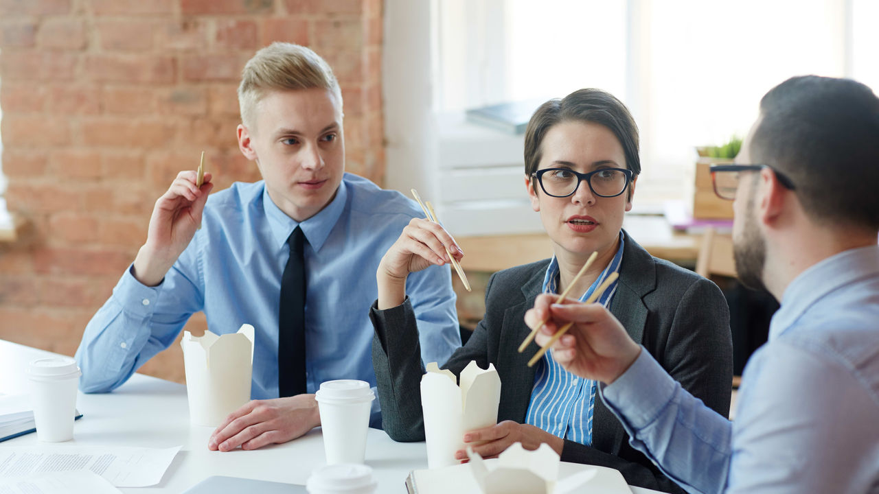 A group of business people sitting around a table.