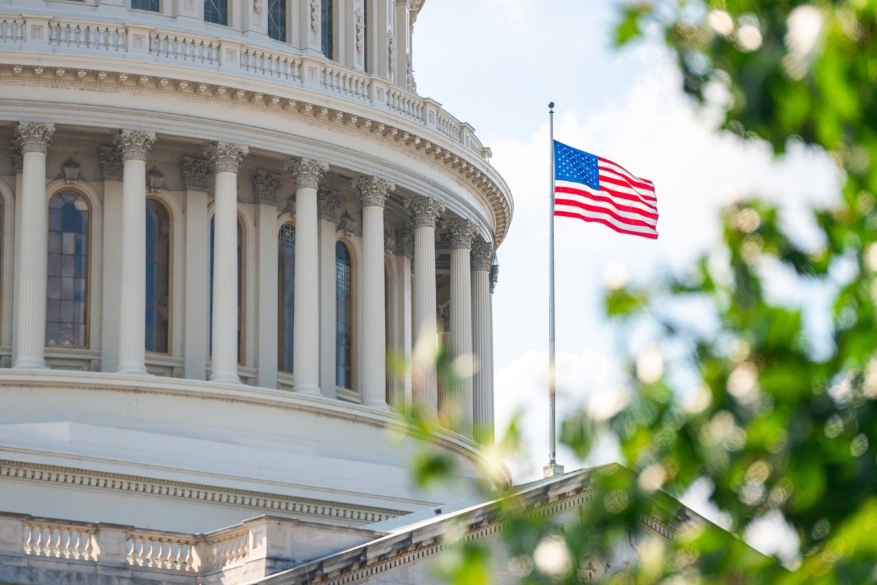 American flag in front of Capitol