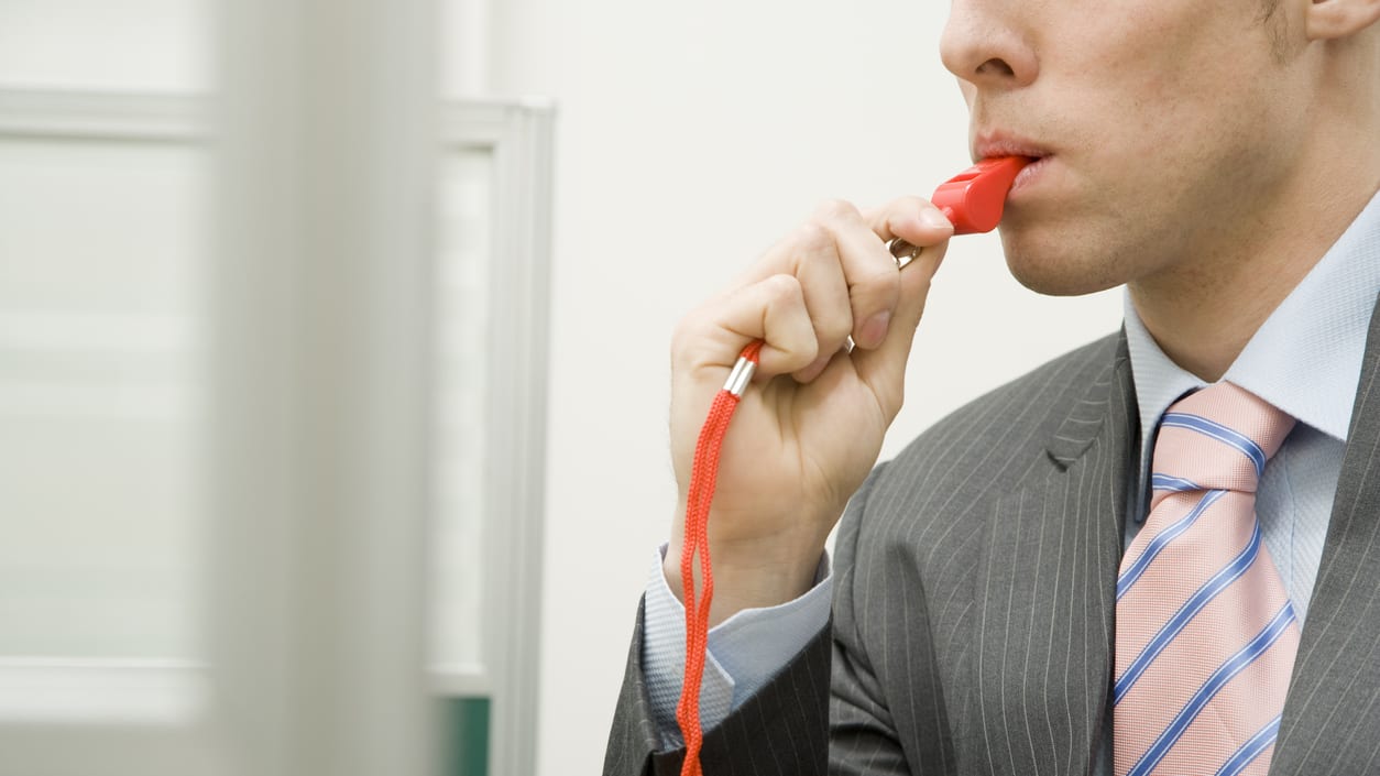 A man in a suit with a red tie.