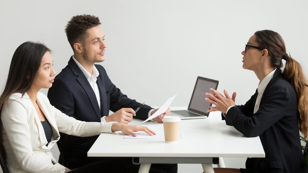 A group of business people talking at a table.