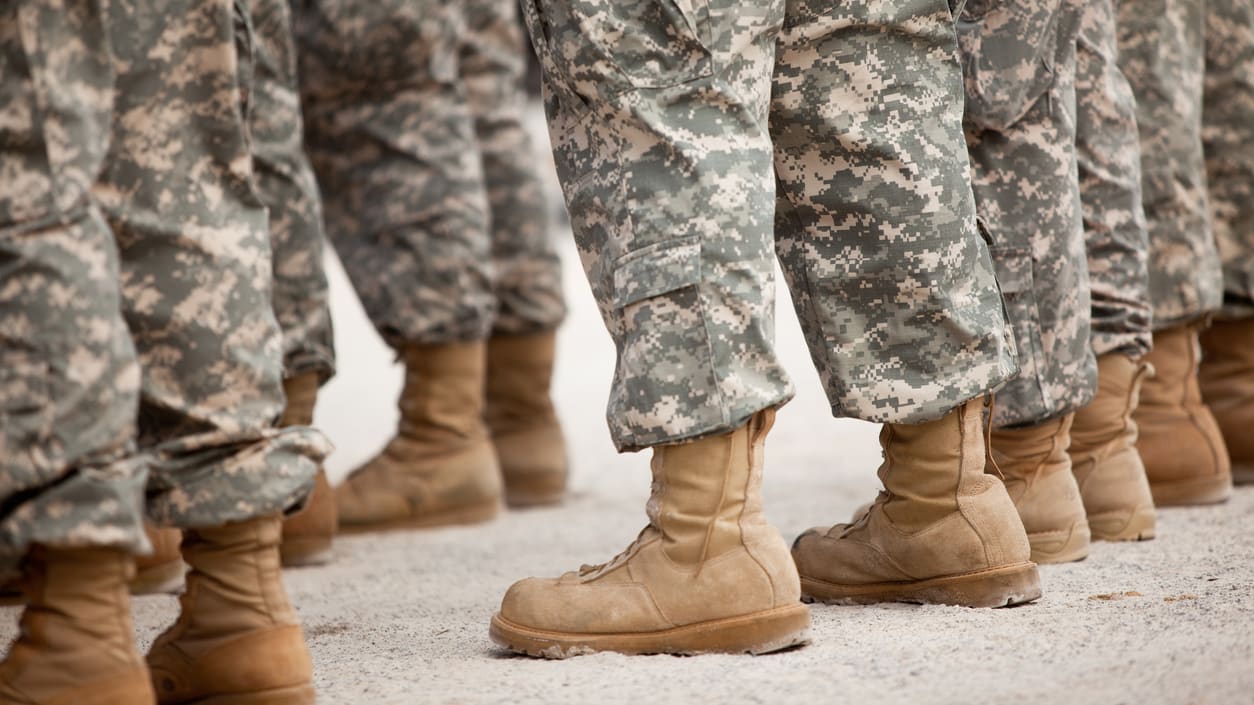 A group of soldiers in uniform standing in a line.