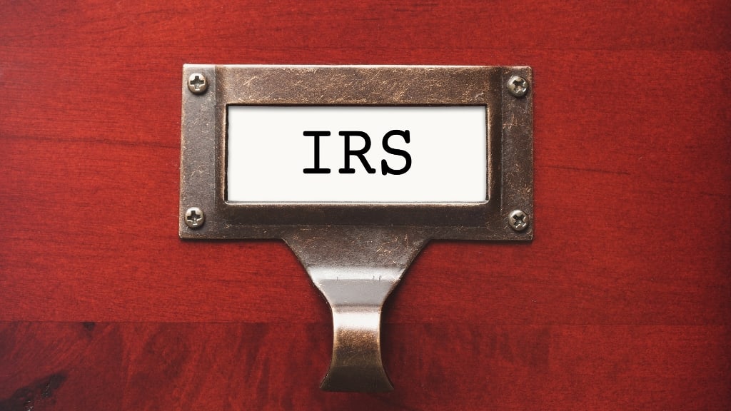 An irs sign hanging on a wooden door.