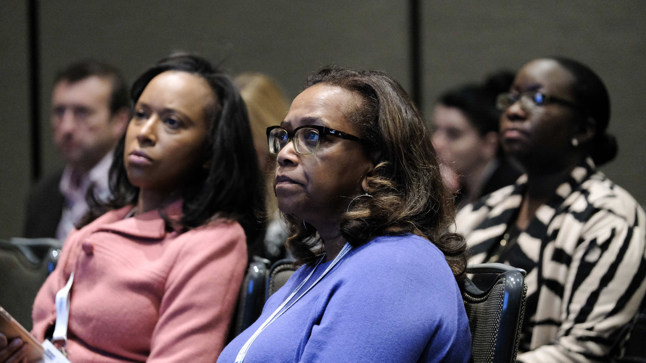 A group of women sitting in a conference room.