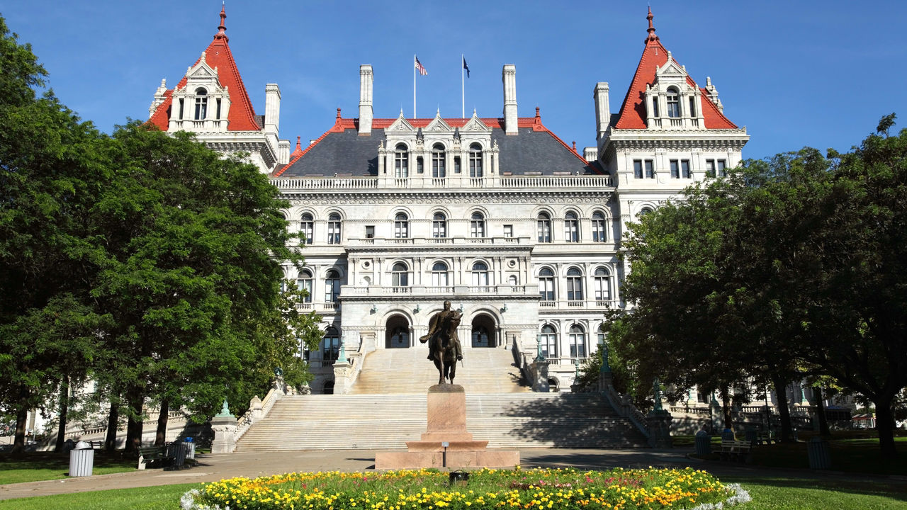 A large building with a statue in front of it.